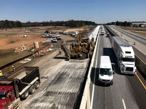 Photo from above of men paving the interstate