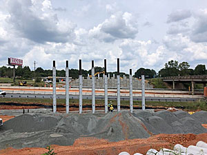 Work has begun on the new bridge at Exit 83.  Shown here (from the West) with Builders First Source to the right.